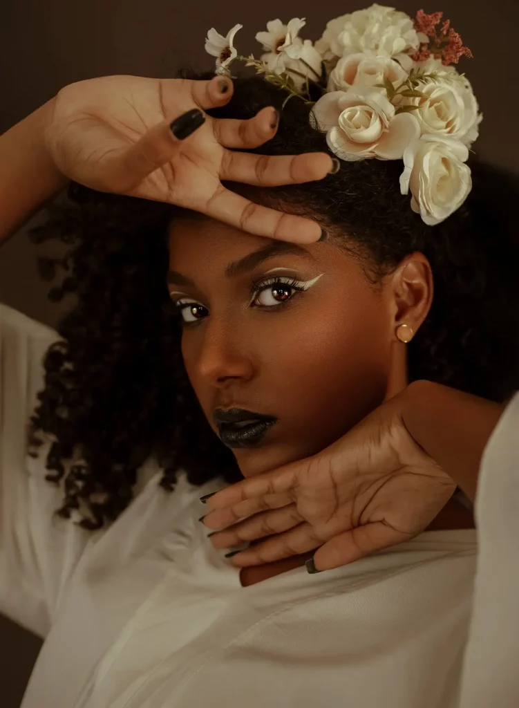 Calm African American lady with floral headband touching face