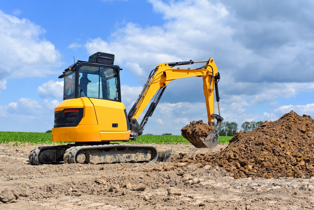excavator with a mound of soil in its bucket