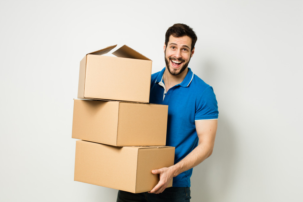 man holding a box and organizing