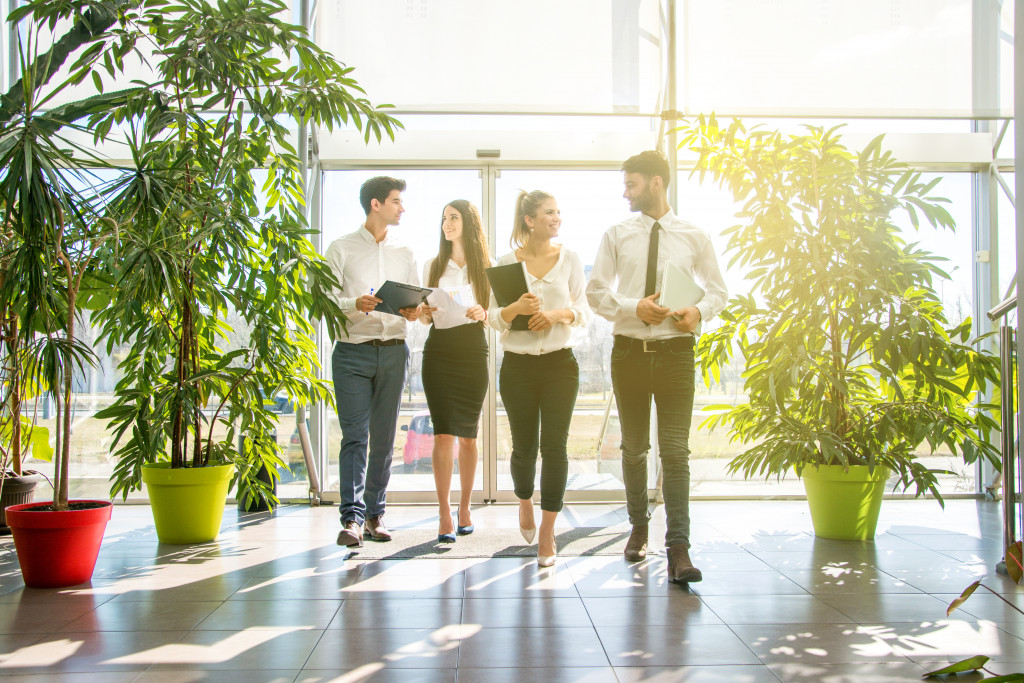 group of employee walking and plants around them