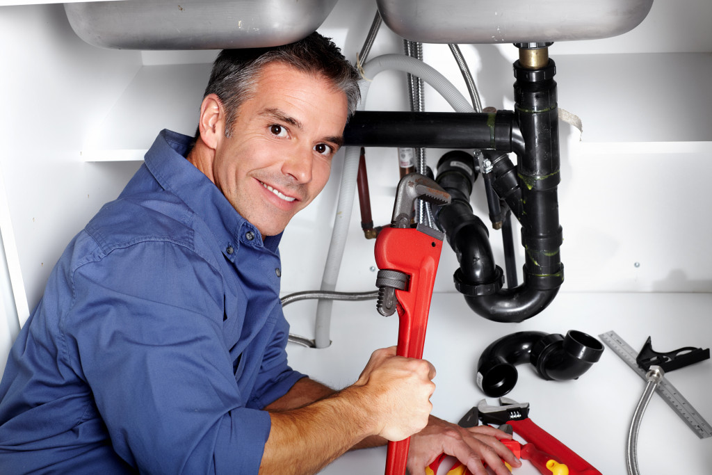 man fixing plumbing