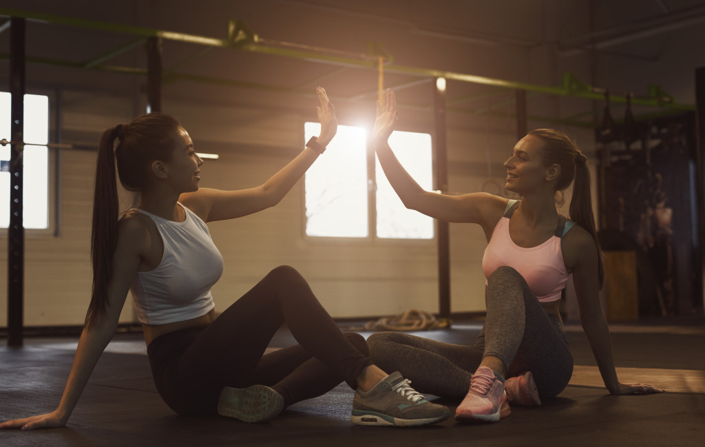 women working out side by side in a gym