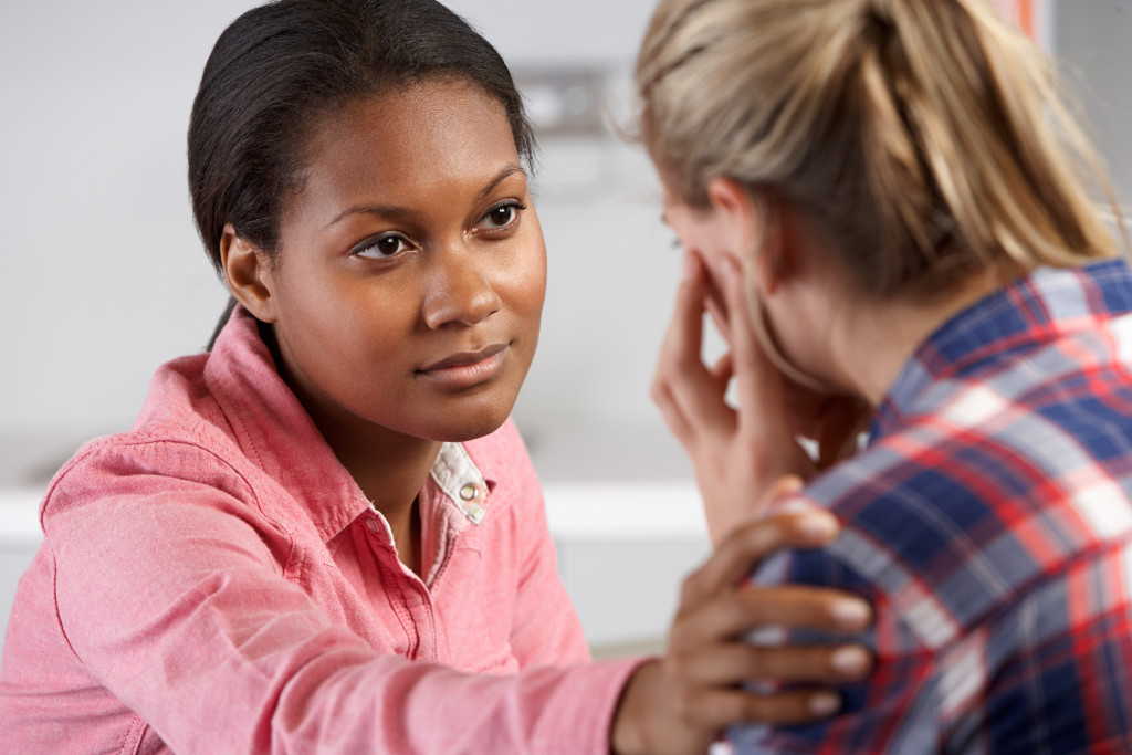 woman calming her friend