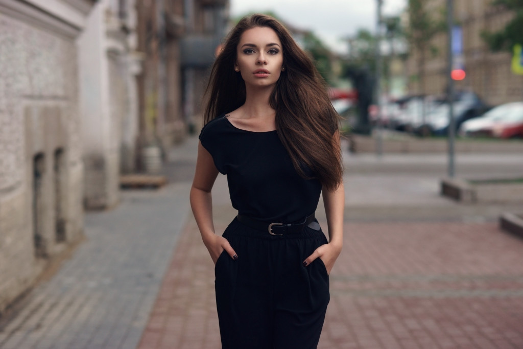 woman in black dress tucking her hands on her pocket