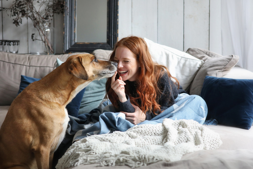 Teenaged girl playing with a big brown dowg