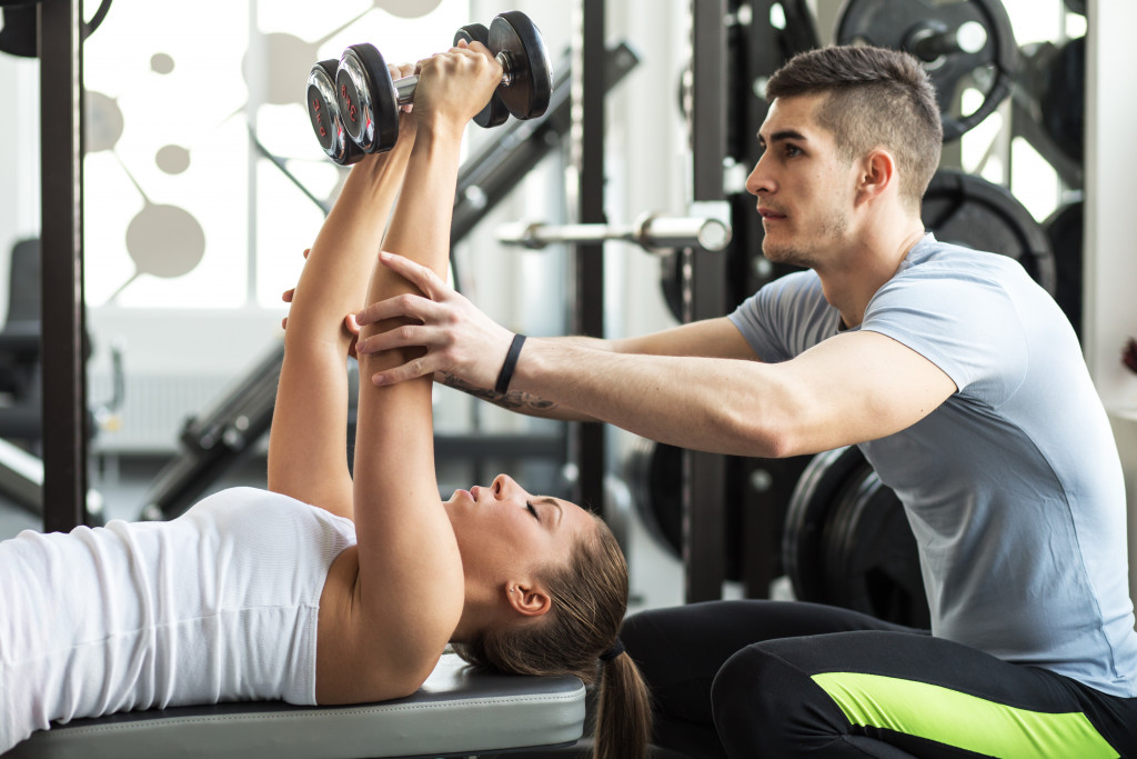 personal trainer helping his client