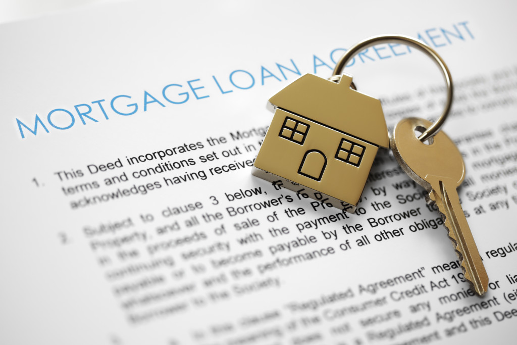 A mortgage loan agreement with house keys on it