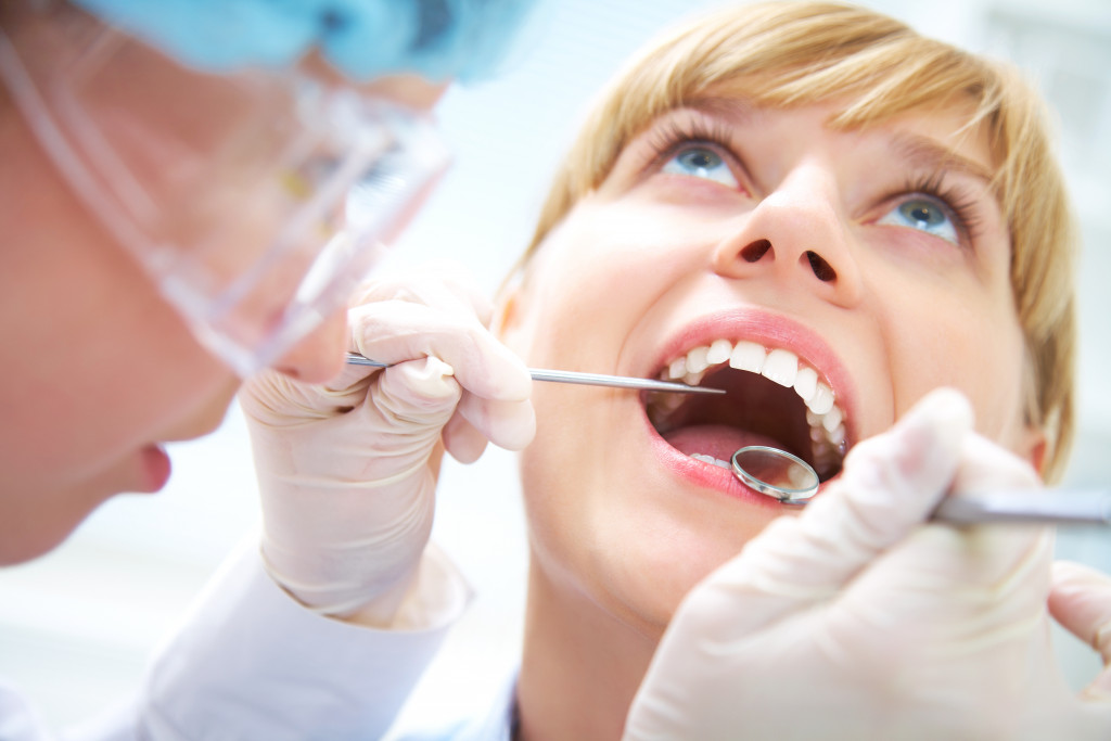 dentist checking patients teeth