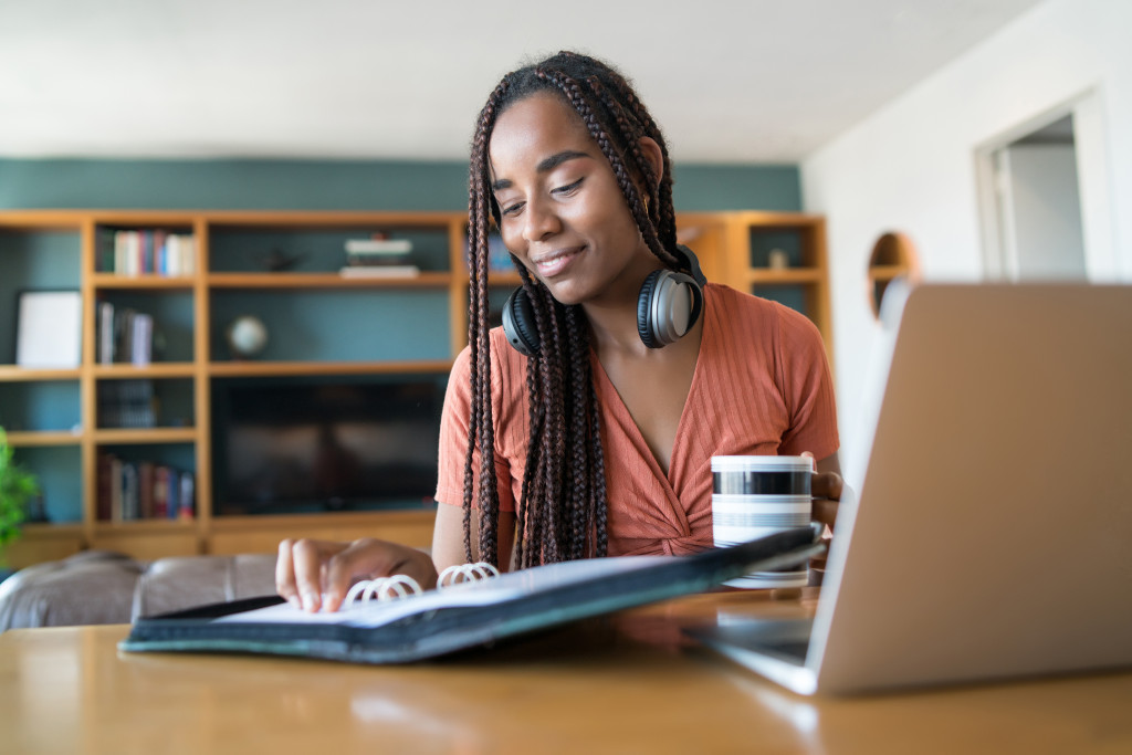 a woman takes a break from working on her computer