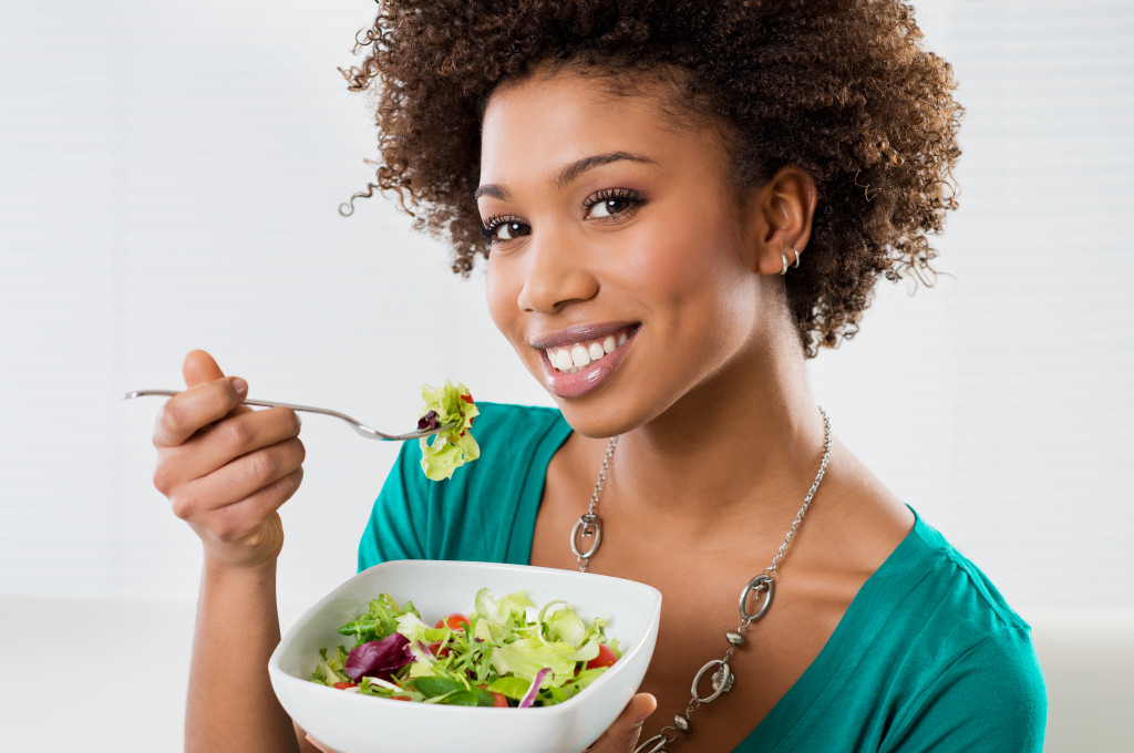Close-up of a woman eating salad at home