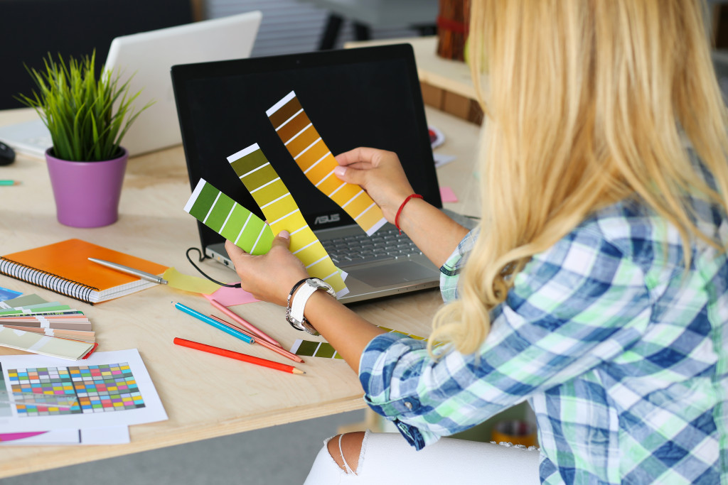 female designer in office working with different color samples