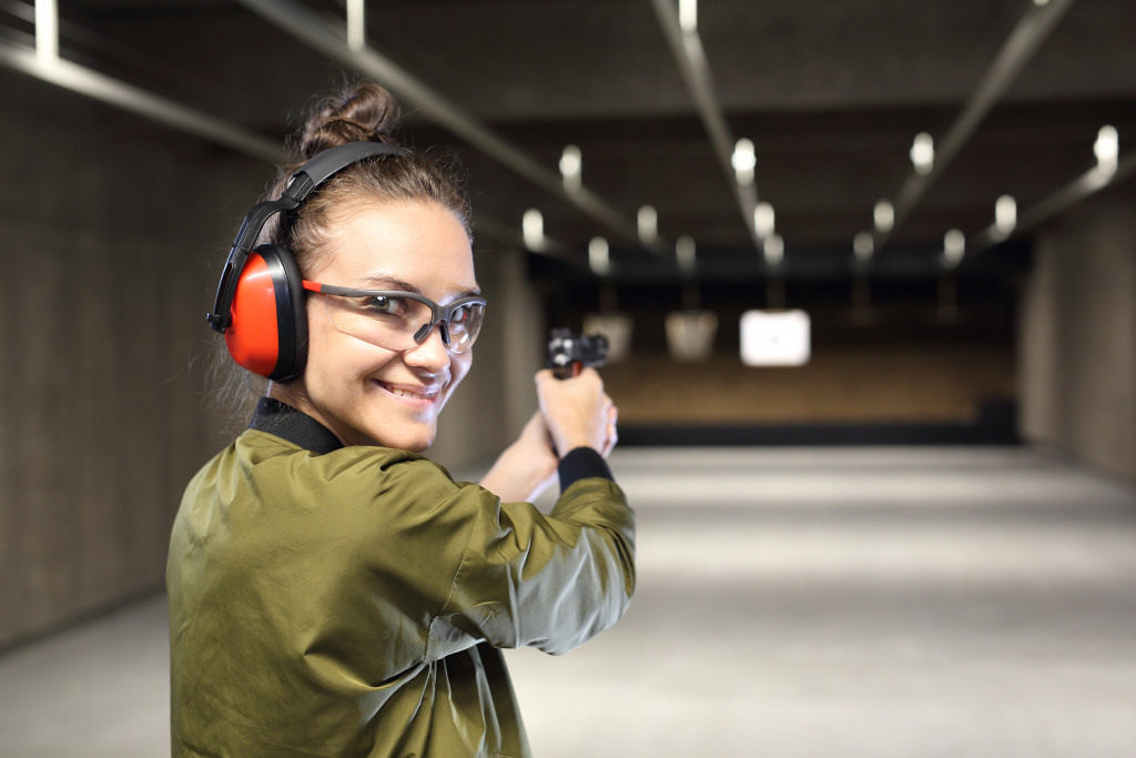 woman holding a gun in a shooting range