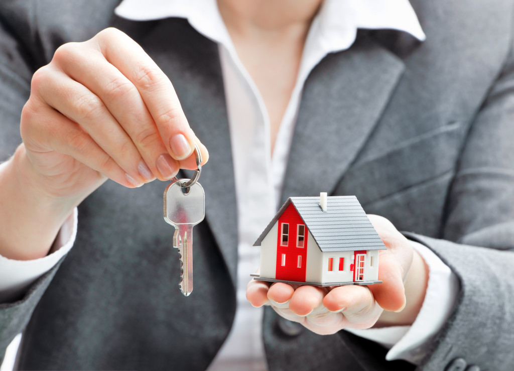 A real estate agent handing over keys to a house