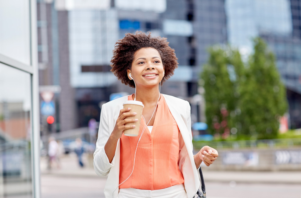 business woman confidently waking with coffee
