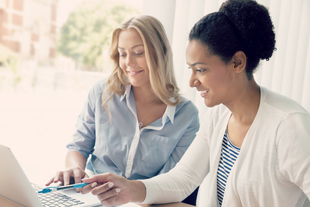 two women working together in an office