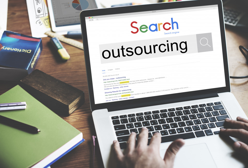 outsourcing concept displayed on laptop screen