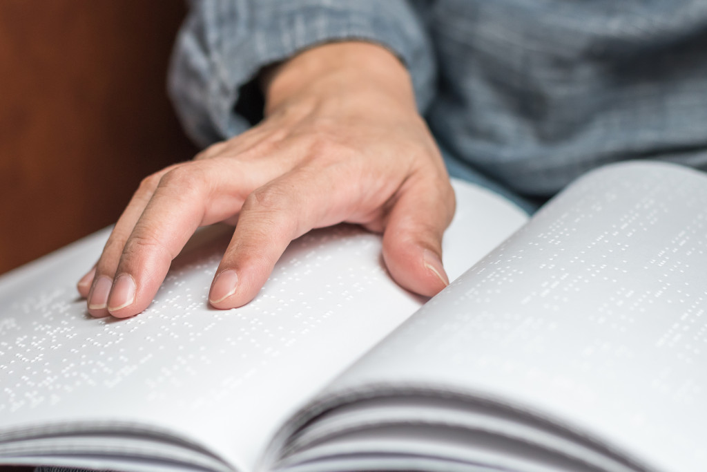 A blind person reading a Braille book