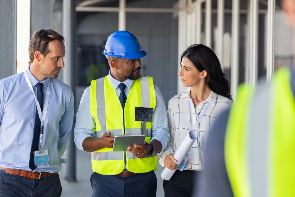 Team in a project having a discussion while walking on a corridor