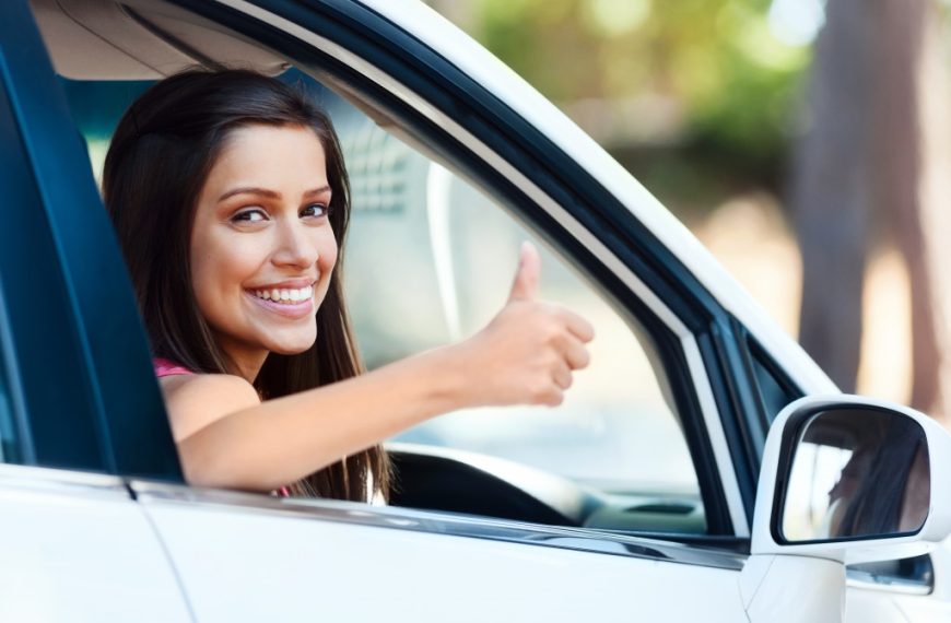 woman thumbs up inside the car