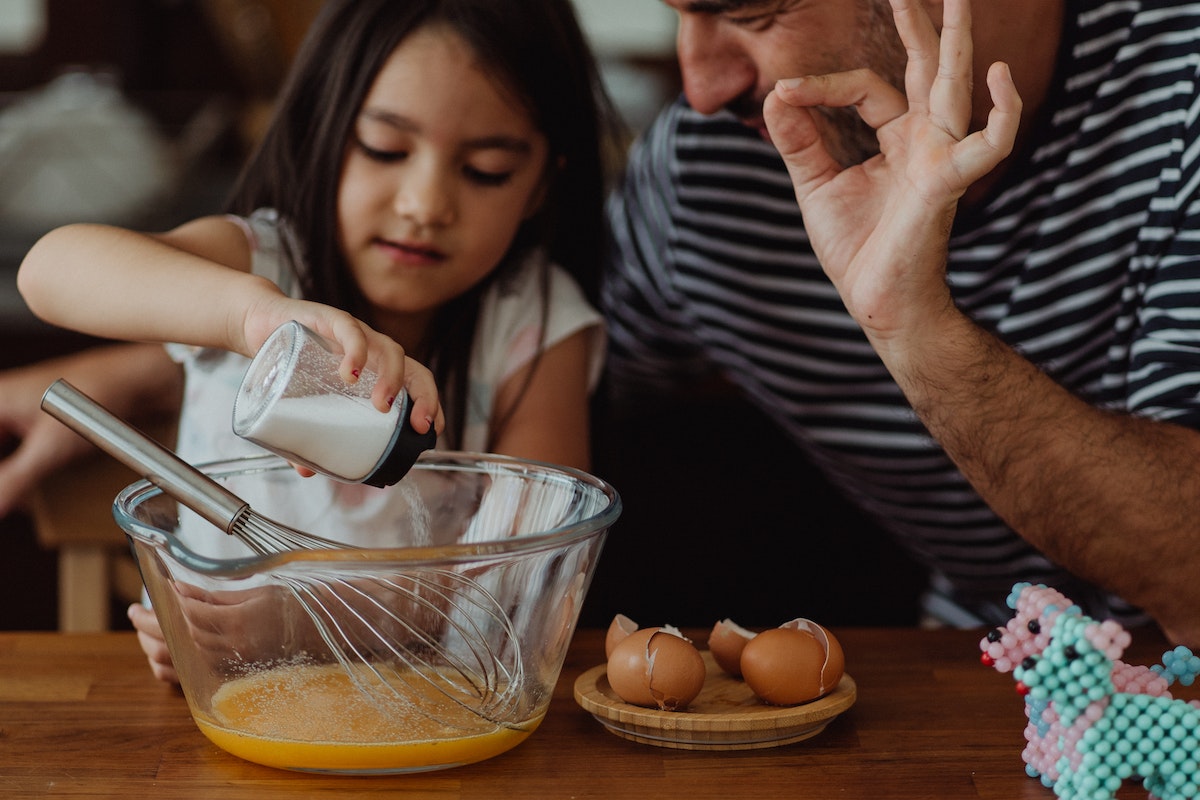 daughter putting the ingredient